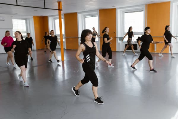 A group of women exercising and dancing in the spacious Orange Studio on Václavská in Brno